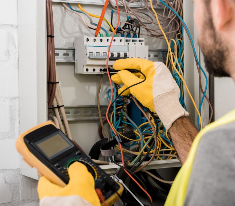 cropped-image-of-electrician-checking-electrical-box-with-multimetr-in-corridor-1